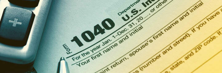 Tax preparer completing a 1040 form
