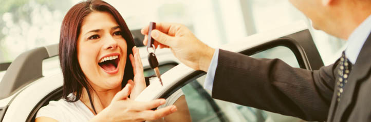 Car salesman giving happy customer keys