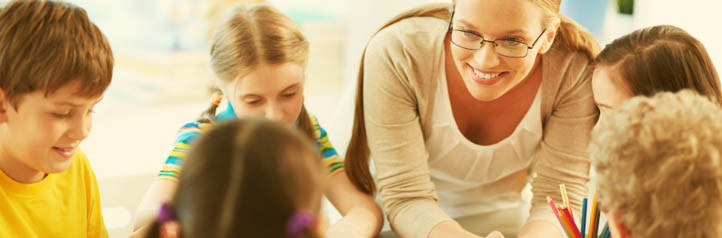 Teacher working with young students