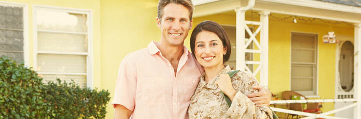 A military family in front of their house