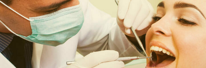 Dentist examining teeth in dental office