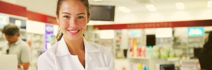 Smiling pharmacy employee poised for customer serivce