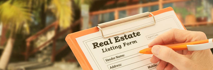 Real estate agent completing a listing form