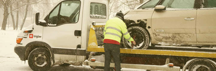 Tow truck operator securing a car