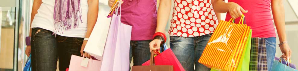 Shoppers at a mall with shopping bags